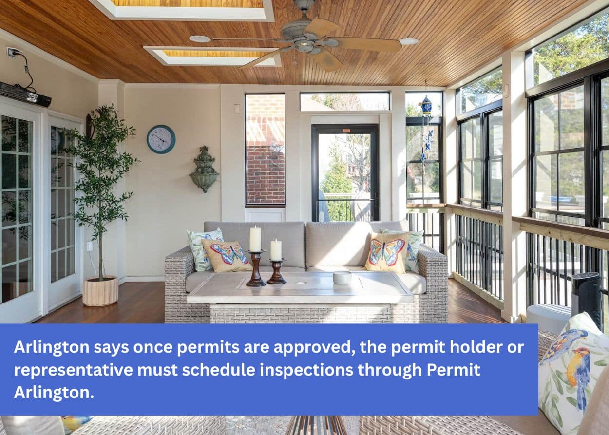 Interior of a screened-in porch with seating area and wood ceiling.
