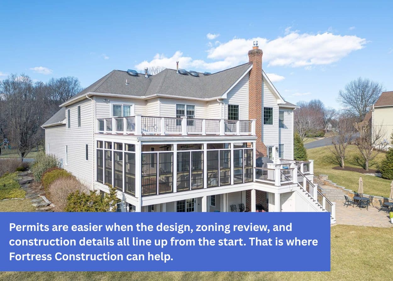 Large multi-level deck and screened porch on the back of a residential home.